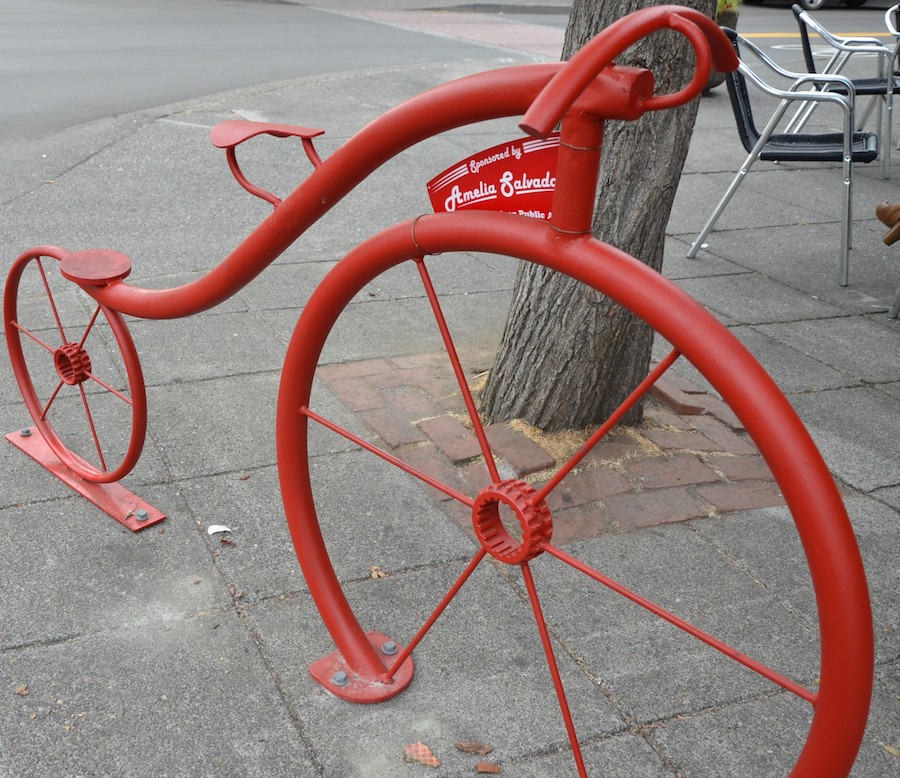 Red bike rack in front of Cafe D.