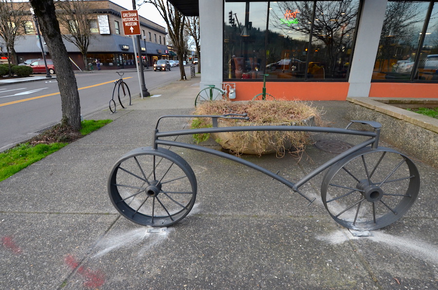 Long bike rack in front of Jazzy Bagel.