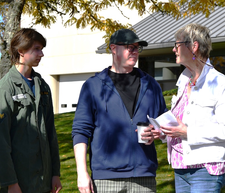 2 men and a woman talking together