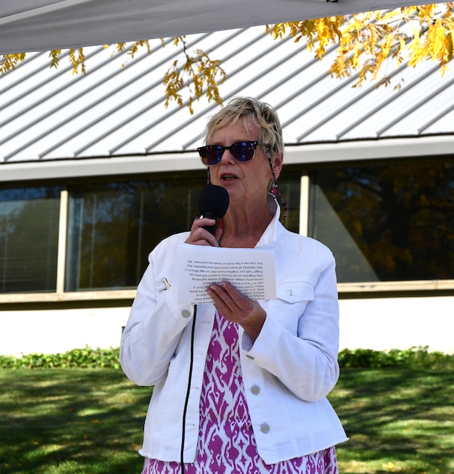 Woman holding microphone and paper