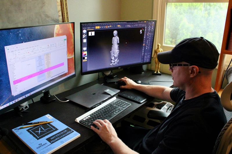 Jeremy working in front of two monitors