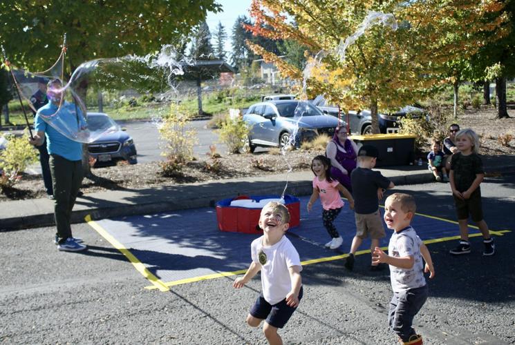 Kids playing with large bubbles.